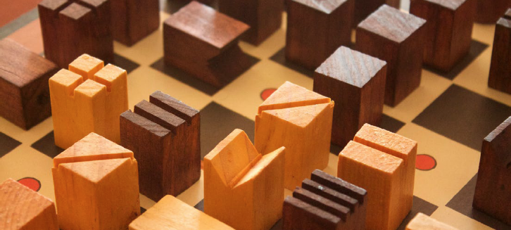 Maze, an abstract cooperative game by Jim Deacove of Family Pastimes. Gameplay is reminiscent of Chess, but instead of advancing a war, players move pieces into threatening positions to prevent war.